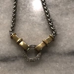 Silver and gold necklace. Chain is braided and it fits close the neck.